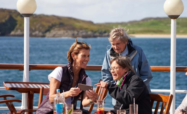 Guests enjoying each others company on the Promenade Deck on the Hebridean Princess cruise ship of Hebridean Island Cruises