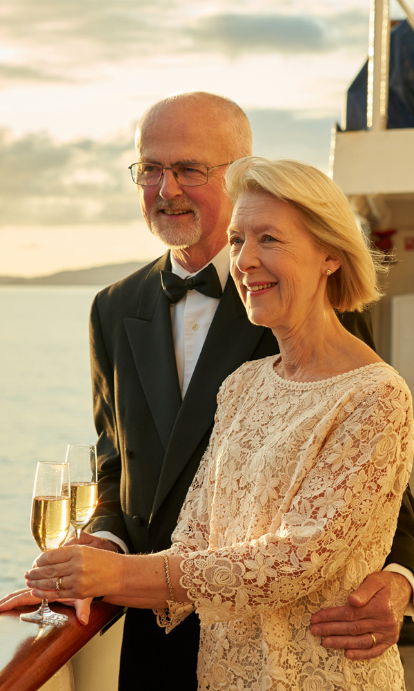 Couple drinking Champagne on deck on the Hebridean Princess cruise ship