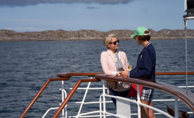 Two guests chatting on the Boat Deck on the Hebridean Princess cruise ship of Hebridean Island Cruises