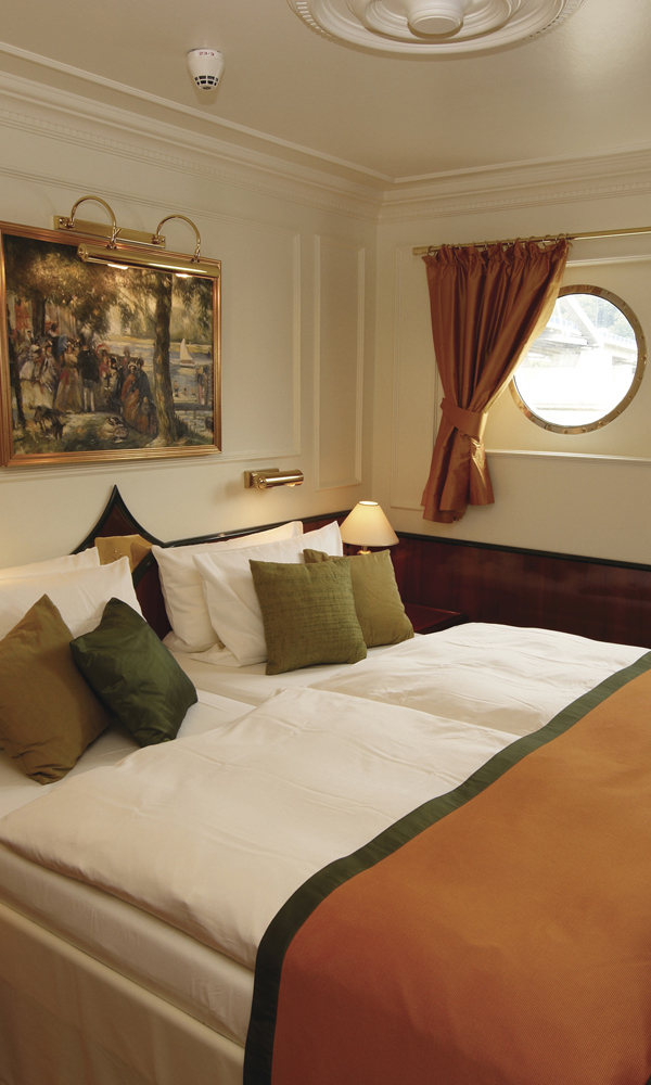 Premium cruise ship cabin with portholes