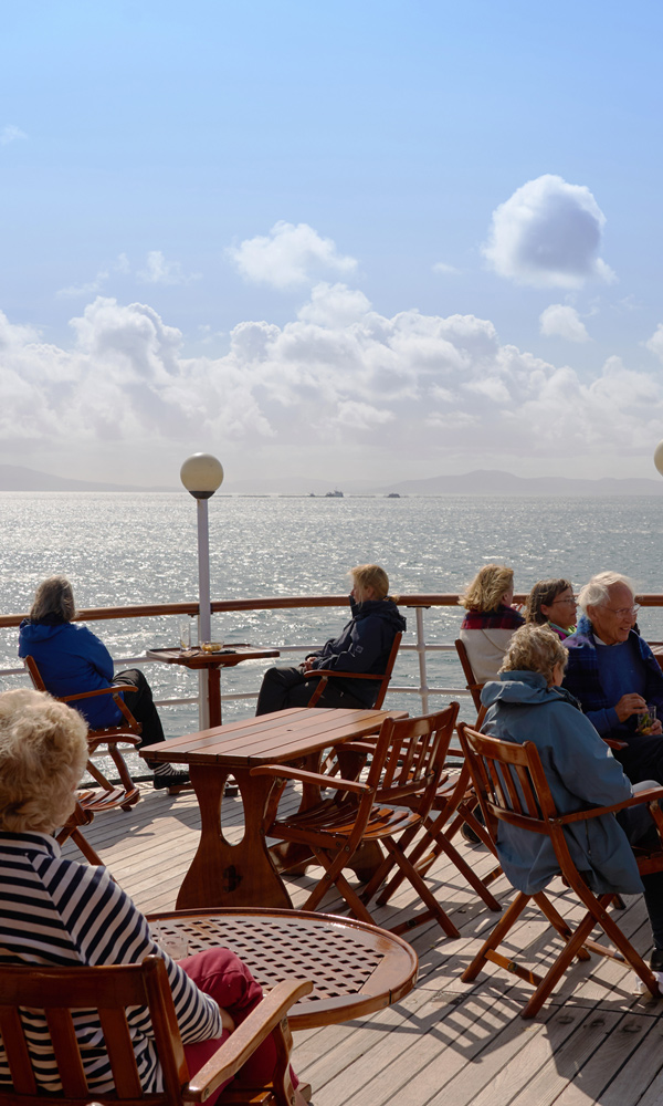 Guests enjoying the view from the Skye Deck on Hebridean Princess