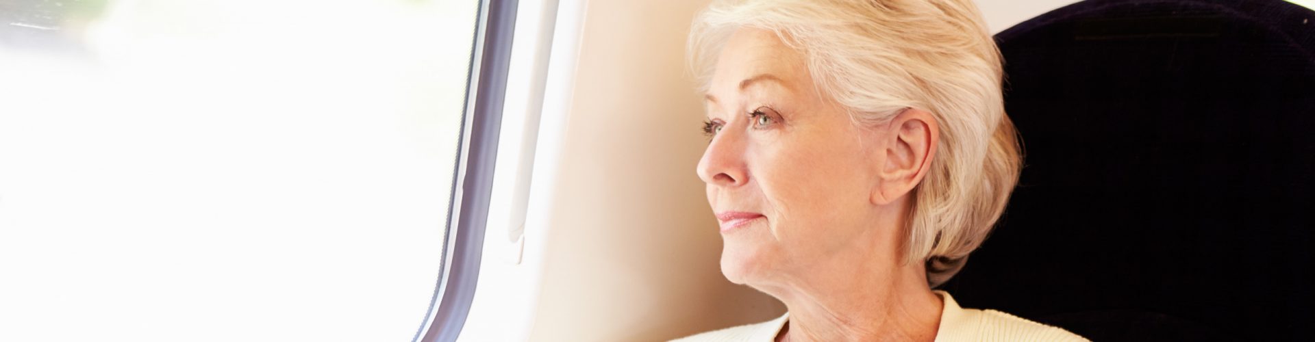 Woman travelling by train looking out of the window