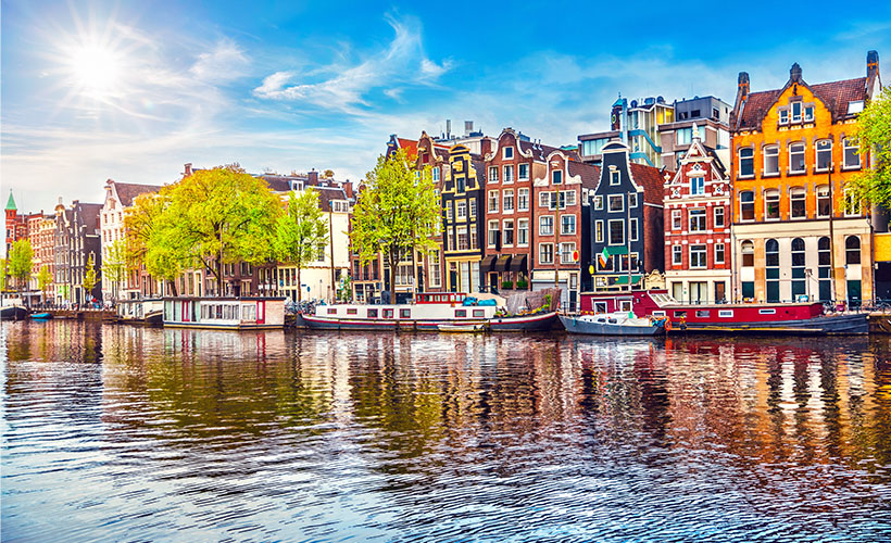 The colourful buildings of Amsterdam lining the waters edge