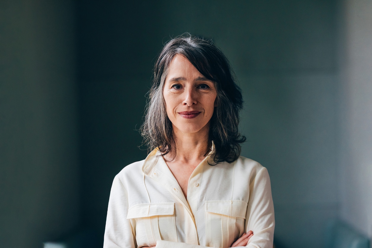 Confident Woman in a Light Blouse Posing with a Calm Expression
